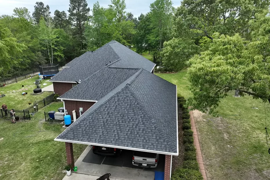 Aerial view of new roof of a home surrounded by trees.